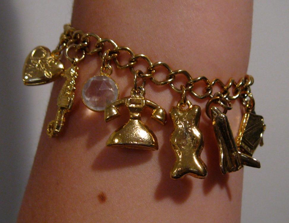 A 1960s charm bracelet with diverse charms representing various life events and achievements