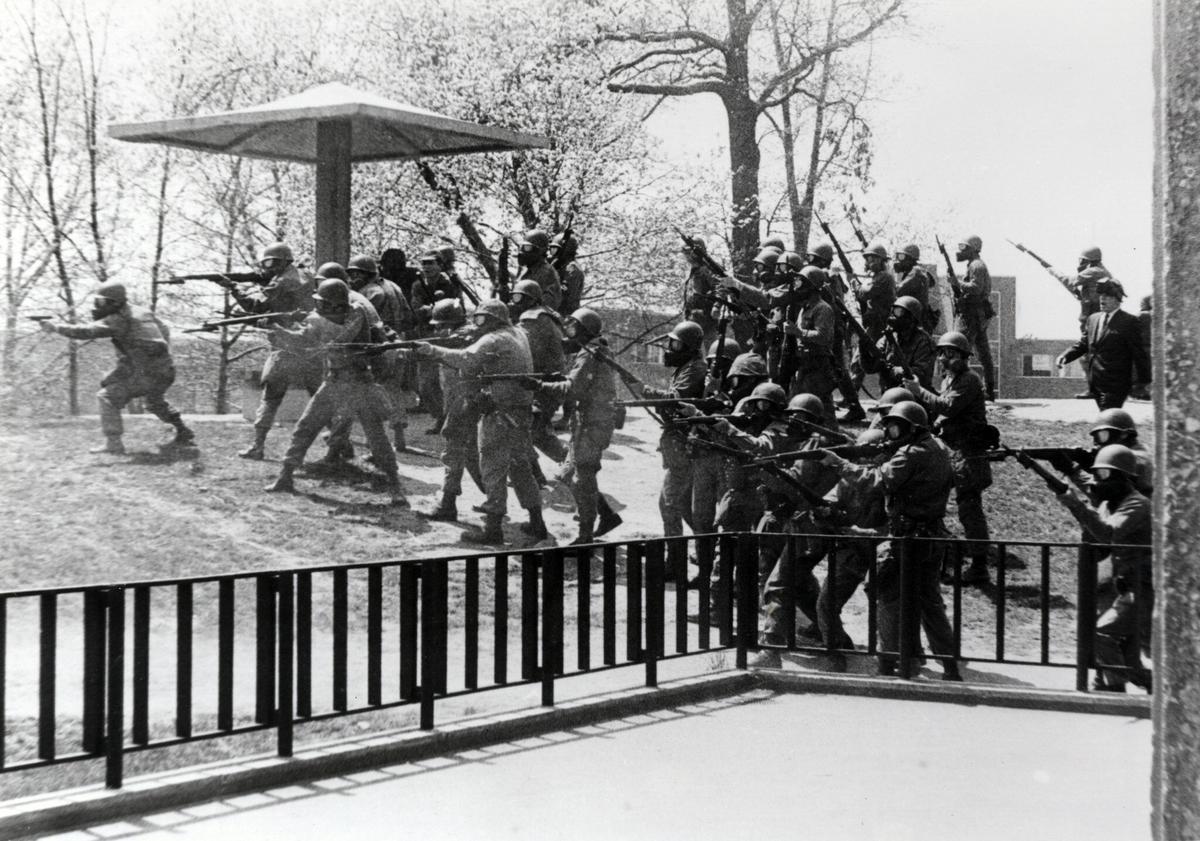 A dramatic recreation of the moment of the Kent State shooting, with National Guard troops firing and students fleeing