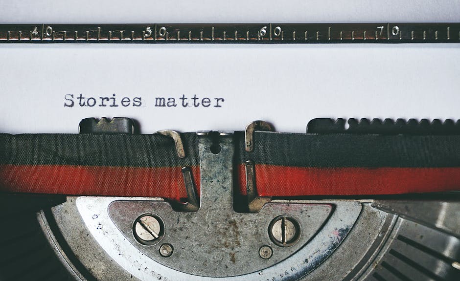 A vintage typewriter with a partially typed manuscript on an author's desk