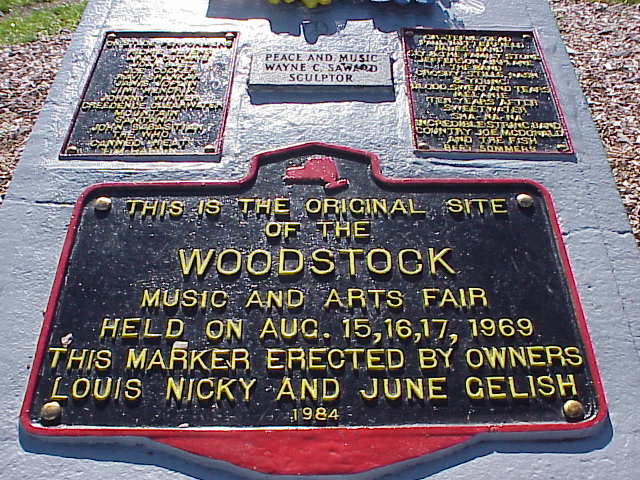 A collection of newspaper headlines and TV screens showing mixed coverage of Woodstock